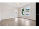 Bright living room featuring hardwood floors, natural light from large windows, and a ceiling fan at 3017 Sanchez St # 1/2, Tampa, FL 33605