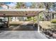 Assigned carport parking near landscaped garden and grounds at 308 Los Prados Dr # 308, Safety Harbor, FL 34695