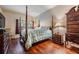 Spacious main bedroom with four-poster bed, wood floors, and a serene window view at 308 Los Prados Dr # 308, Safety Harbor, FL 34695