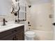 Stylish bathroom featuring modern fixtures, dark vanity, a large mirror, and shelving over the toilet at 31031 Whitlock Dr, Wesley Chapel, FL 33543