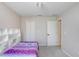 Bedroom with a playful bed, white shelving, and a view into an adjacent room through a white door at 31031 Whitlock Dr, Wesley Chapel, FL 33543