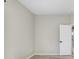 An open bedroom space featuring modern gray walls and light wood flooring at 31031 Whitlock Dr, Wesley Chapel, FL 33543