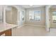 Bright breakfast nook featuring neutral walls, tile flooring, and natural light from plantation shuttered windows at 31031 Whitlock Dr, Wesley Chapel, FL 33543