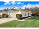 Well-manicured lawn and landscaping surround this charming single-story home with an attached two-car garage at 31031 Whitlock Dr, Wesley Chapel, FL 33543