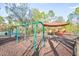 Community playground featuring swings, slides, and covered play areas for enjoyment at 31031 Whitlock Dr, Wesley Chapel, FL 33543