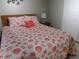 Bedroom featuring a bed with seashell-themed bedding, a wooden headboard, and neutral wall color at 3161 Lake Pine S Way # F1, Tarpon Springs, FL 34688