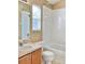 Bright bathroom with a tub/shower combo, vanity with a sink, and a large mirror at 3320 Broken Bow Dr, Land O Lakes, FL 34639