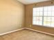 Sunlit bedroom with a large window overlooking the outdoors at 3320 Broken Bow Dr, Land O Lakes, FL 34639