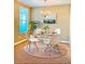 Dining room with a glass table, white chairs, and a jute rug at 3320 Broken Bow Dr, Land O Lakes, FL 34639