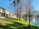 Waterfront view of the home's exterior elevation and serene lake setting at 3320 Broken Bow Dr, Land O Lakes, FL 34639