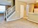 Inviting living room featuring a staircase, view of the kitchen, and neutral carpeting at 3320 Broken Bow Dr, Land O Lakes, FL 34639