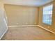 Open living room with carpet flooring, a staircase, and natural light from a large window at 3320 Broken Bow Dr, Land O Lakes, FL 34639