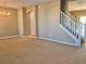 Spacious living room with carpet flooring, a staircase, and a chandelier at 3320 Broken Bow Dr, Land O Lakes, FL 34639