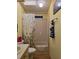 Bright bathroom features a toilet and a shower/tub combo with a floral curtain at 36830 Kimela Ave, Zephyrhills, FL 33542