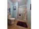 Comfortable bathroom featuring a glass shower, toilet, and tasteful decor at 36830 Kimela Ave, Zephyrhills, FL 33542