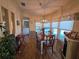 Inviting dining area with a chandelier, a wood table, and natural light from the surrounding windows at 36830 Kimela Ave, Zephyrhills, FL 33542