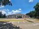 Wide angle shot of the building, showing the ample parking and pleasant landscaping at 36830 Kimela Ave, Zephyrhills, FL 33542