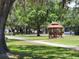 A gazebo offers a place to sit and enjoy the shady trees and green space at 36830 Kimela Ave, Zephyrhills, FL 33542