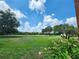 Beautiful view of the golf course with pink flowers in the foreground at 36830 Kimela Ave, Zephyrhills, FL 33542