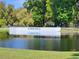 Betmar Golf sign over the water hazard, creating a picturesque golf course setting at 36830 Kimela Ave, Zephyrhills, FL 33542