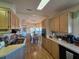 Cozy kitchen featuring wood cabinets and countertops, seamlessly connected to a well-lit dining area at 36830 Kimela Ave, Zephyrhills, FL 33542