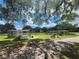 The property includes park amenities: a shaded picnic pavilion with tables, benches, and grassy areas at 36830 Kimela Ave, Zephyrhills, FL 33542