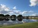 Scenic pond reflecting the sky, surrounded by mature trees and well maintained homes at 36830 Kimela Ave, Zephyrhills, FL 33542