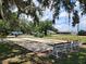 Outdoor shuffleboard courts framed by mature trees in a serene community setting at 36830 Kimela Ave, Zephyrhills, FL 33542