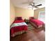 Bedroom with two twin beds, hardwood floors, and plenty of natural light at 3917 103Rd N Ave, Clearwater, FL 33762