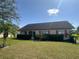 Attractive single-story home with green lawn, shrubs, and red shutters offers charm and curb appeal at 3917 103Rd N Ave, Clearwater, FL 33762