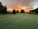 Scenic golf course view at sunrise featuring lush green fairway and colorful sky at 3917 103Rd N Ave, Clearwater, FL 33762