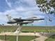 Outdoor display of a jet fighter plane with American flag and signage nearby at 3917 103Rd N Ave, Clearwater, FL 33762