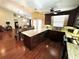 Remodeled kitchen with a large island, granite counters, and dark wood cabinetry at 3917 103Rd N Ave, Clearwater, FL 33762