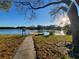 Scenic lake view with a charming pier, perfect for enjoying the peaceful waterfront setting at 3917 103Rd N Ave, Clearwater, FL 33762