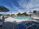 Community pool featuring lounge chairs and umbrellas, providing a great place to relax at 3917 103Rd N Ave, Clearwater, FL 33762