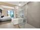 A luxury bathroom boasting a glass shower and a stylish bathtub next to the main bedroom at 450 Knights Run Ave # 1005, Tampa, FL 33602