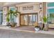 Elegant lobby entrance featuring glass doors, planters, and exterior lighting at 450 Knights Run Ave # 1005, Tampa, FL 33602