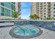 A luxurious hot tub invites relaxation, situated between residential buildings under a clear sky at 450 Knights Run Ave # 1005, Tampa, FL 33602