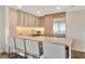 Modern kitchen featuring stainless steel appliances, bar-style seating, and hardwood cabinets at 450 Knights Run Ave # 1005, Tampa, FL 33602