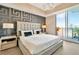 Bedroom with decorative wall, chandelier, and balcony access with city views at 450 Knights Run Ave # 1005, Tampa, FL 33602