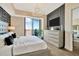 Bedroom showcasing a decorative wall, balcony, and modern dresser at 450 Knights Run Ave # 1005, Tampa, FL 33602