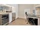 Minimalist home office with a modern desk, storage, and a stylish wet bar area at 450 Knights Run Ave # 1005, Tampa, FL 33602