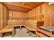 Relaxing sauna room featuring wood-paneled walls, tiered seating, and a heater for an immersive experience at 450 Knights Run Ave # 1005, Tampa, FL 33602