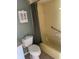 Bathroom featuring a toilet, shower/tub combo with vintage medicine cabinet at 4715 Jasper Dr # 208, New Port Richey, FL 34652