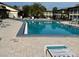 Community pool with lounge chairs surrounded by lush landscaping, and a shallow end at 4715 Jasper Dr # 208, New Port Richey, FL 34652