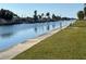 Scenic waterfront view with a concrete walk way with grass to the side of it at 4715 Jasper Dr # 208, New Port Richey, FL 34652