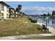 Waterfront view with docks and waterway and canal side walkways and green space at 4715 Jasper Dr # 208, New Port Richey, FL 34652