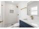 Stylish bathroom with a walk-in shower, gold fixtures, and a sleek vanity at 4908 Stolls Ave, Tampa, FL 33615