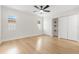 Bright, minimalist bedroom with a ceiling fan and two large closets at 4908 Stolls Ave, Tampa, FL 33615