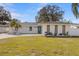 Charming single-story home with a brick facade, manicured lawn, and a modern design at 4908 Stolls Ave, Tampa, FL 33615